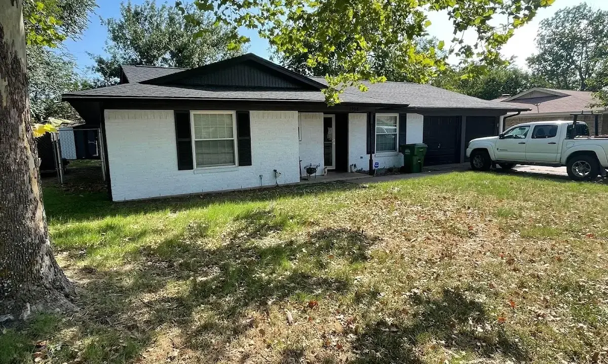 Professional roofing crew working on a residential roof in Gulf Hills